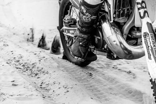 Free Grayscale Photography of Motorcycle on Sand Stock Photo