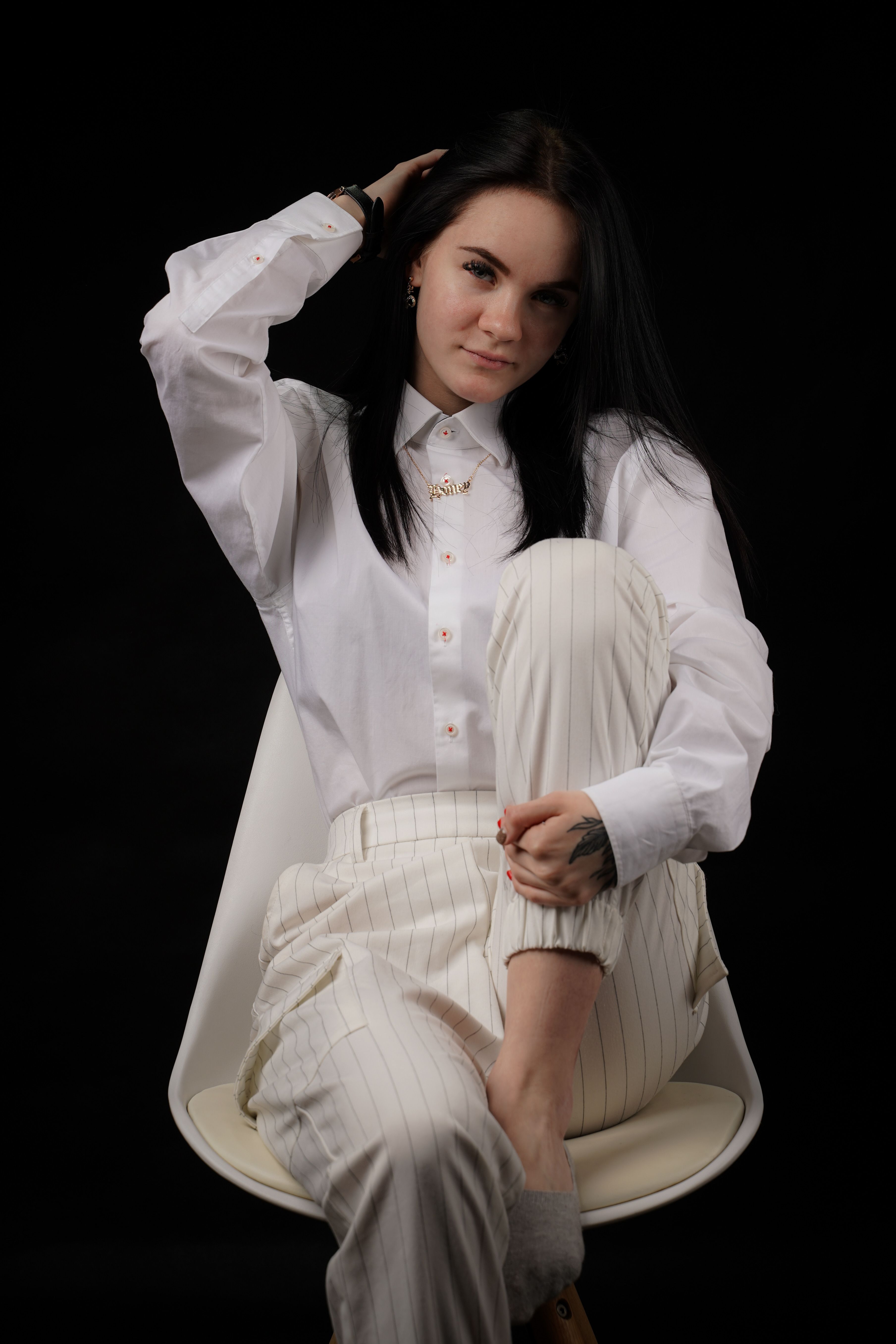 Woman in a White Long Sleeved Shirt Sitting on a Chair · Free Stock Photo