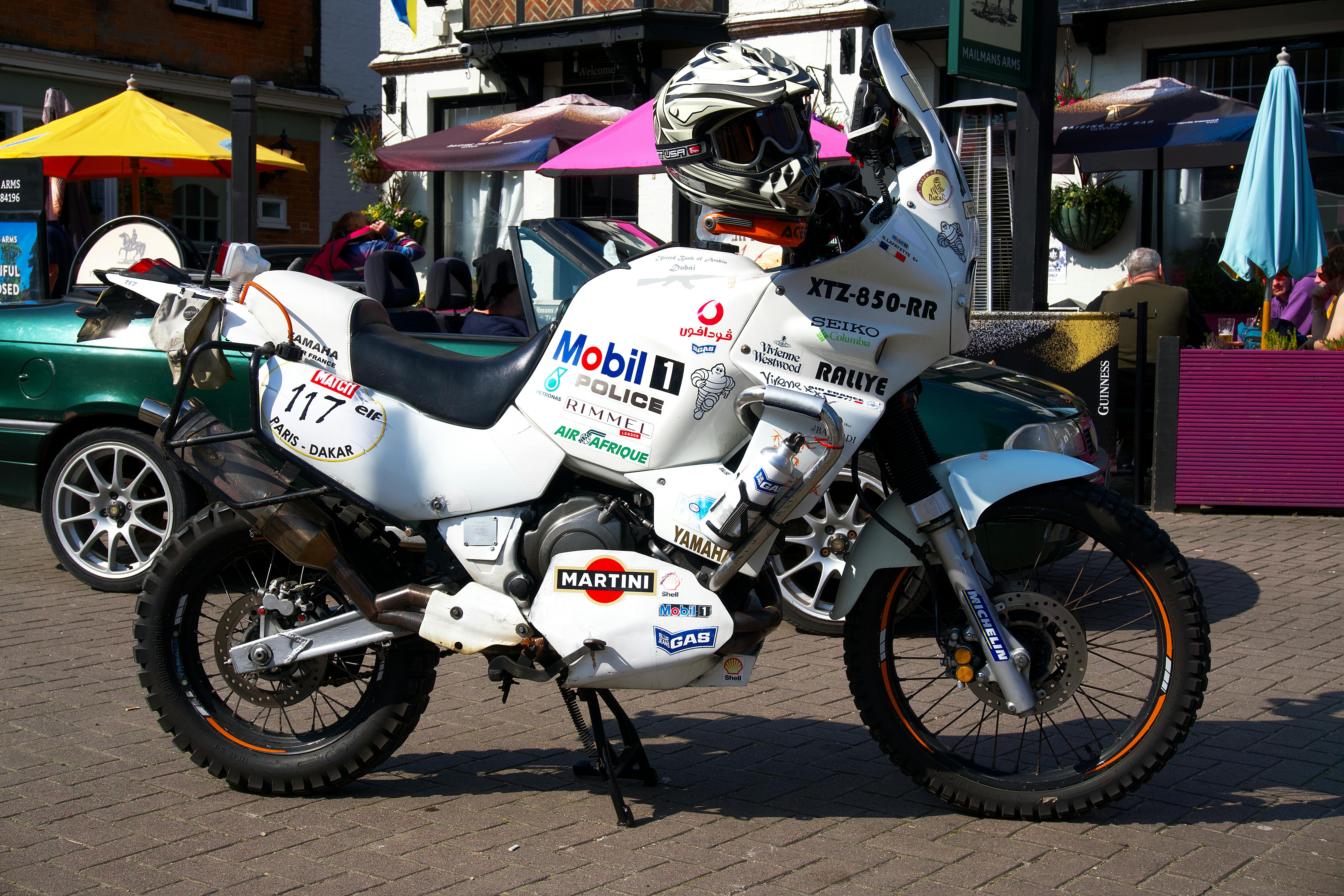 Helmet on a White Motorcycle Parked on Paved Road
                    