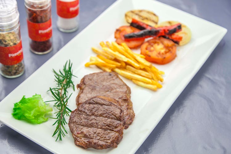 Steak And Fries On A White Platter