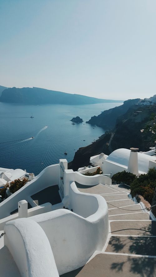 Free Explore Santorini's iconic white architecture overlooking the blue Aegean Sea. Stock Photo