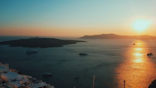 Free A serene sunset view over the Aegean Sea with boats and distant islands. Stock Photo