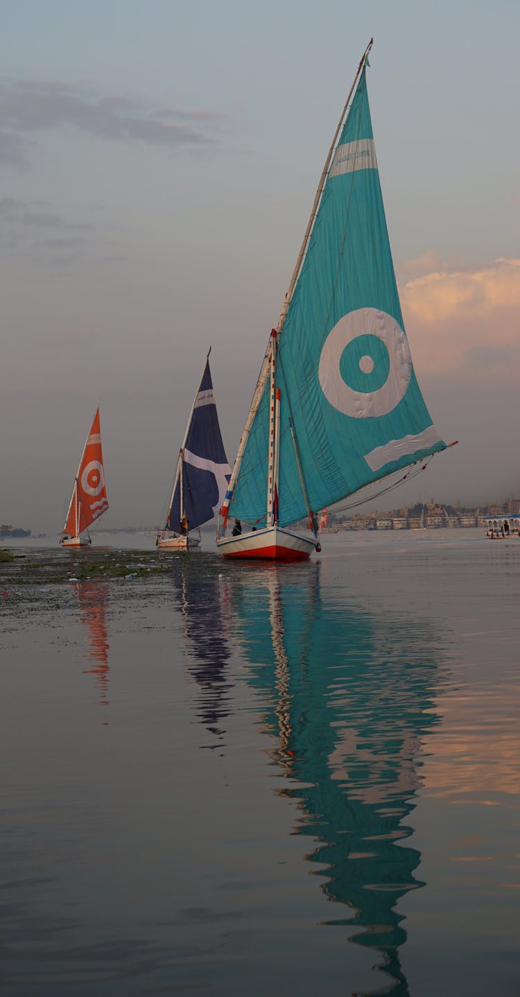 Colorful Sailboats At Sea Under A Blue Sky