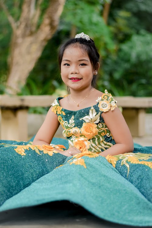 Photo of a Girl Wearing Gown Smiling