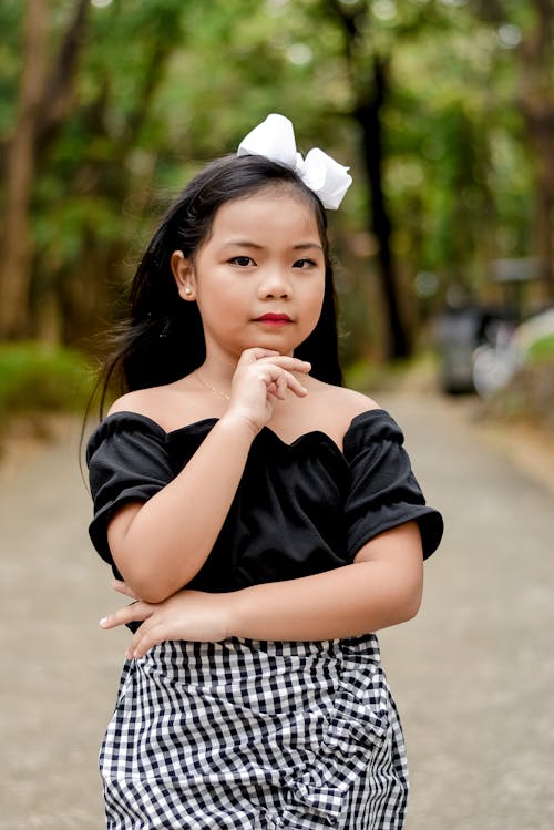 Girl in Black Top with Her Hand on Her Chin