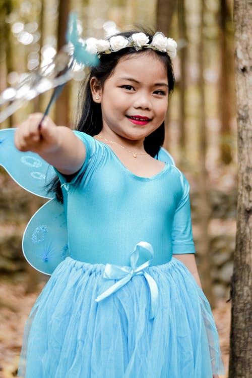 Free Girl in Blue Costume Smiling Stock Photo
