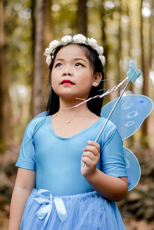 Free Girl in Blue Costume Looking Up Stock Photo