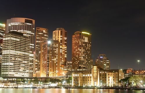 Free A stunning city skyline with skyscrapers illuminated against the night sky. Stock Photo