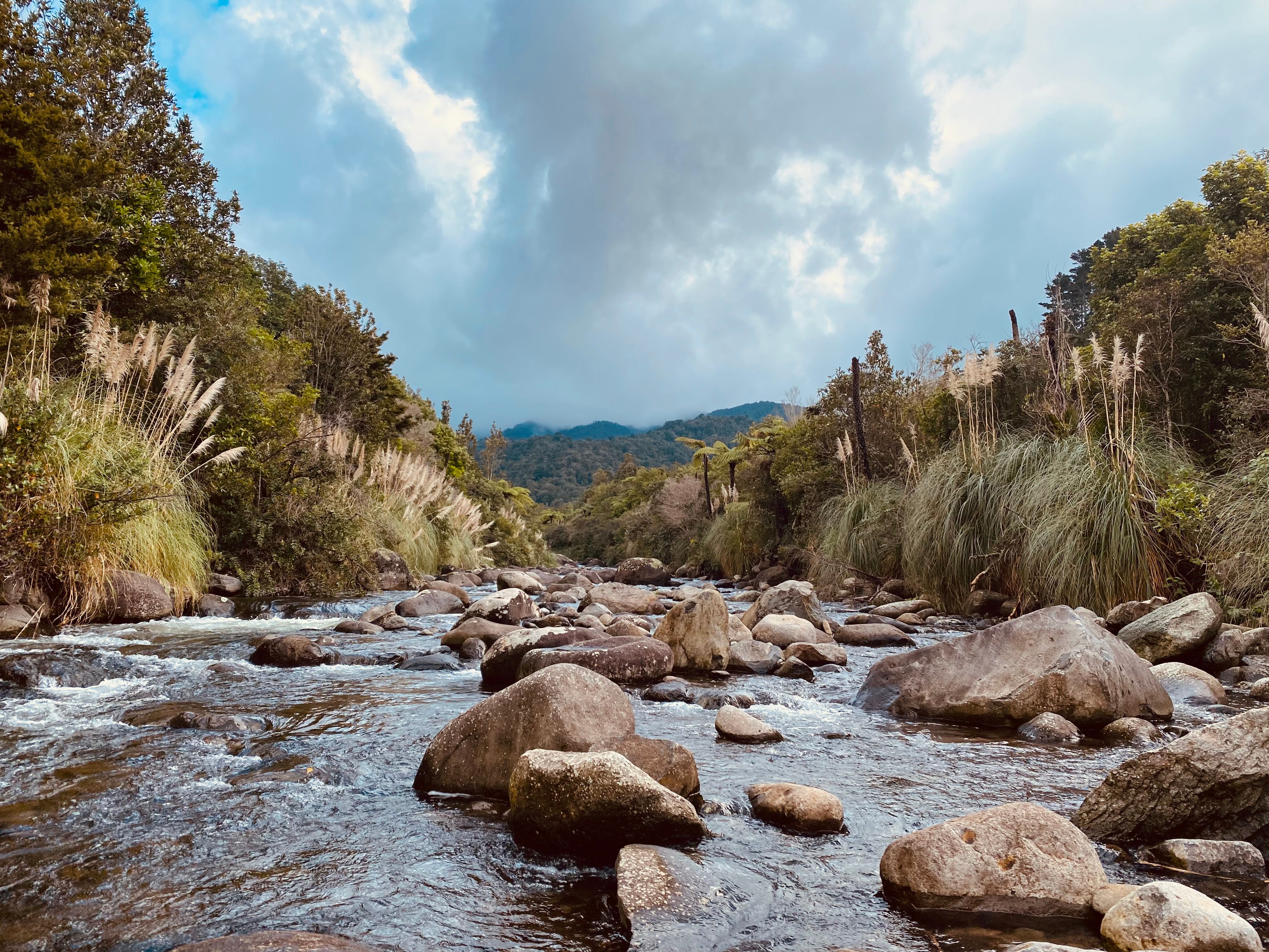 Rocky Flowing River a Under Cloudy Sky · Free Stock Photo