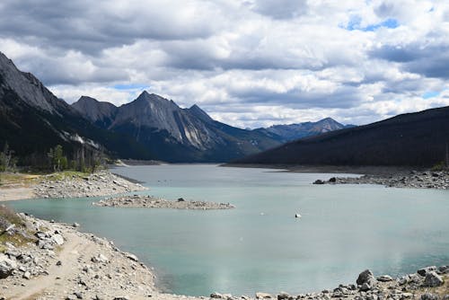 Mountain and Lake under Cloudy Sky