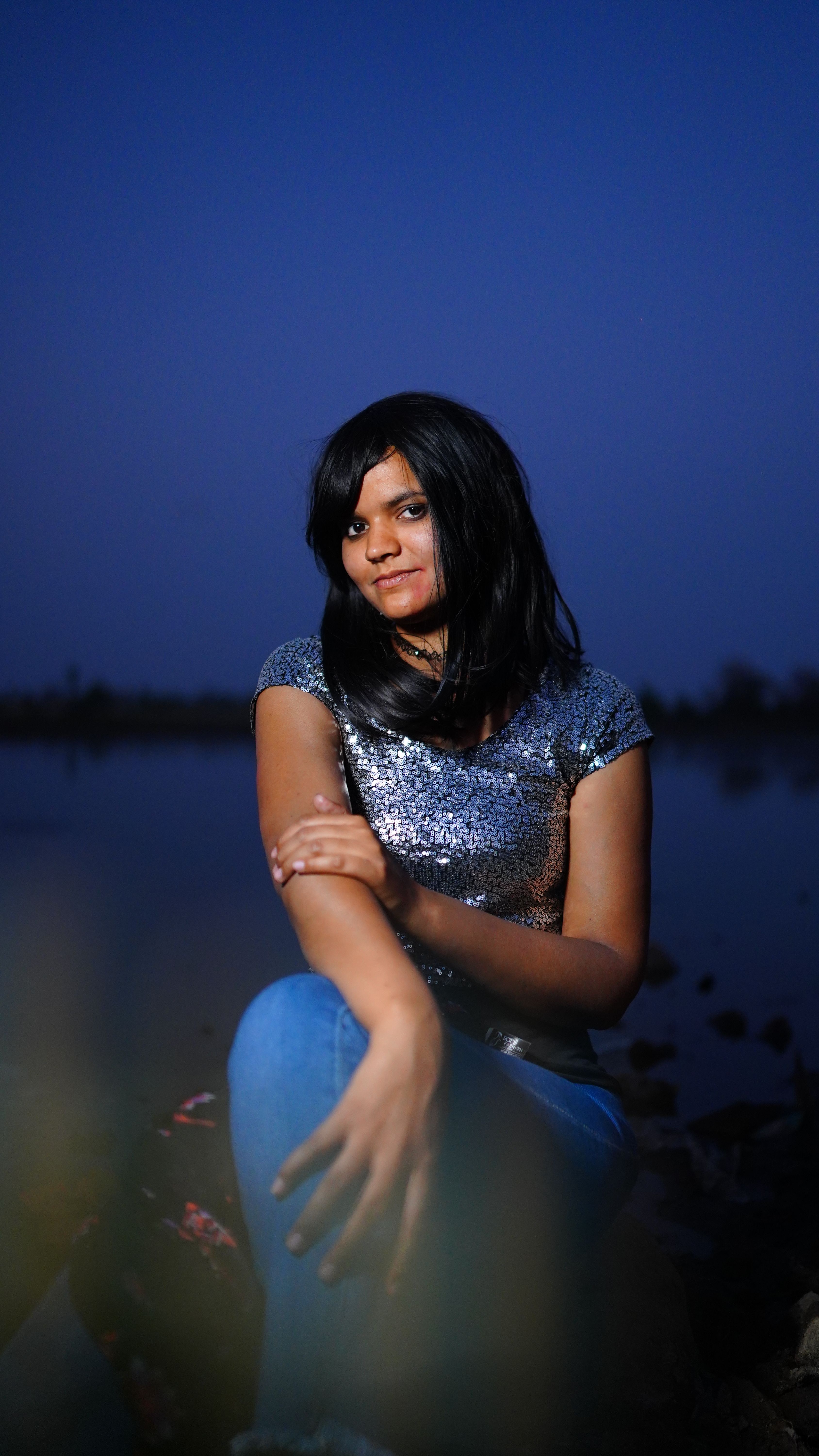 Portrait Of a Woman With Black Hair Posing By the Lake · Free Stock Photo