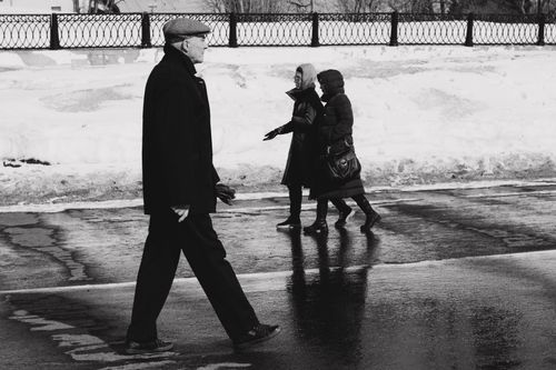 Free Black and white photo of people walking on a snowy street in Arkhangelsk, Russia during winter. Stock Photo