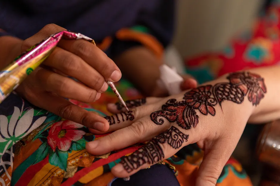 Woman applying a temporary tattoo at home, showing the easy application process without tools