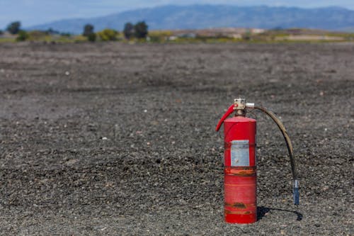 Free Rusty Fire Extinguisher on the Ground Stock Photo
