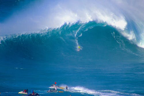 Free Surfer Riding a Big Wave Stock Photo