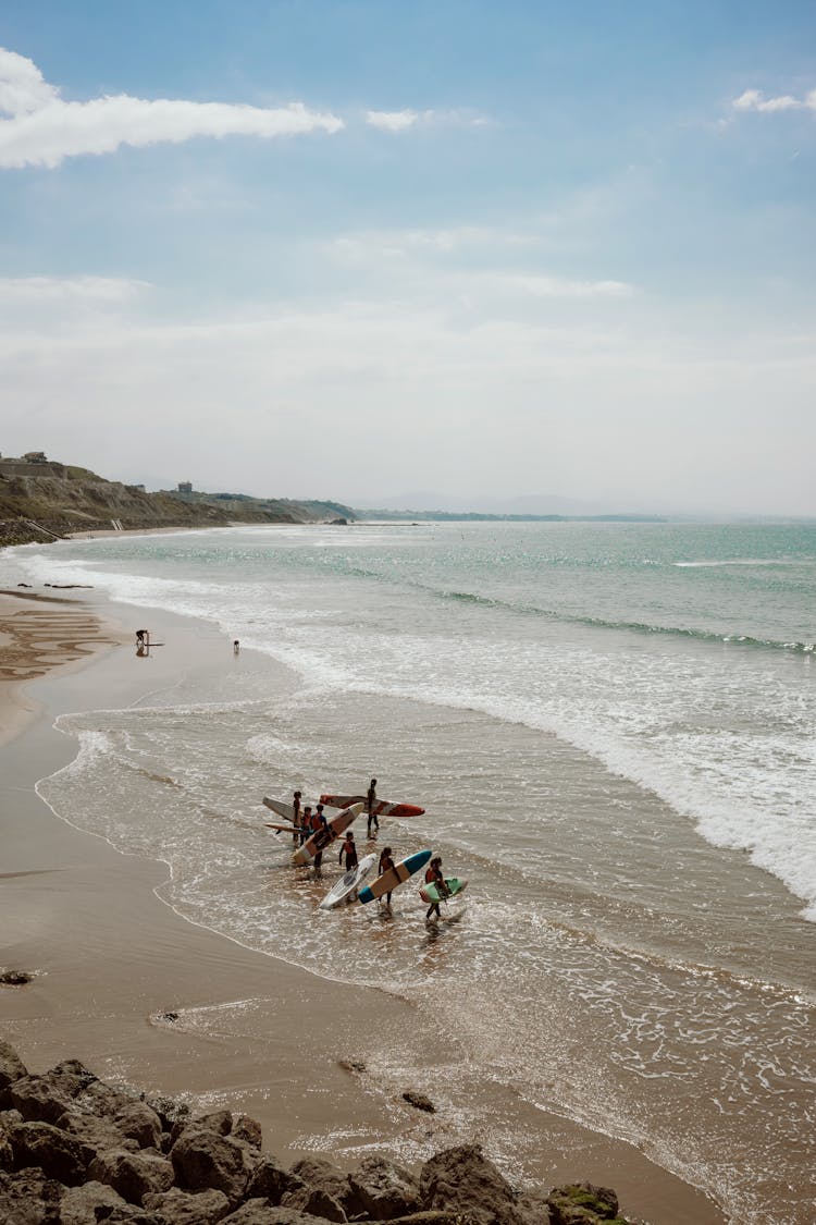 Surfers On The Beach 