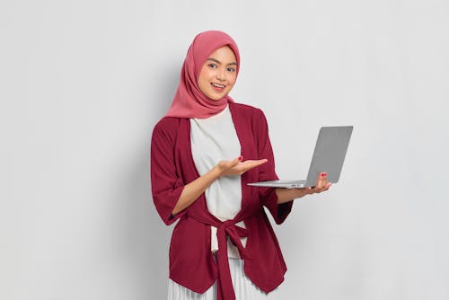 Woman Wearing Hijab Holding her Laptop