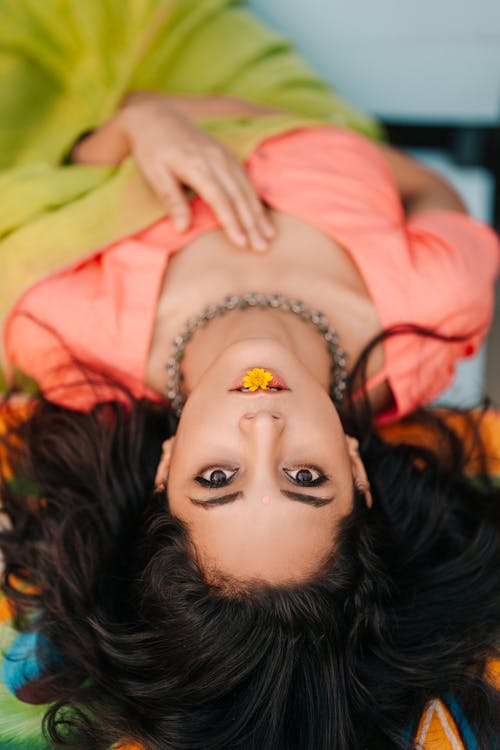 Free Beautiful Woman with Yellow Flower on Her Lips Stock Photo