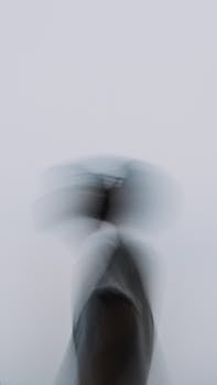 Artistic motion blur with unrecognizable figure on white background.