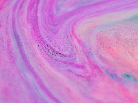 A close-up of a vibrant pink and purple abstract swirl creating a dynamic artistic texture.