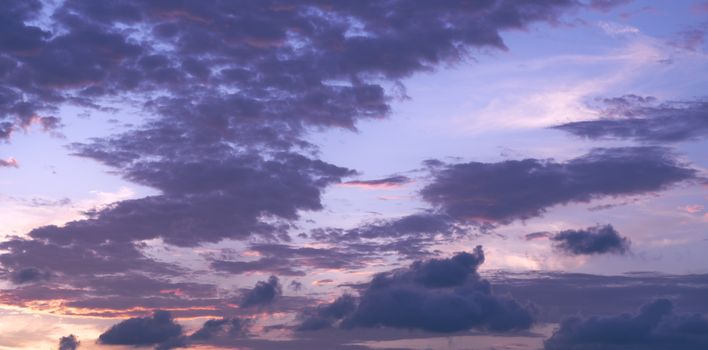 Purple and pink hues paint the twilight sky with dramatic clouds.