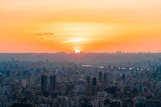 Breathtaking sunset over a sprawling city skyline creating a vibrant urban scene.