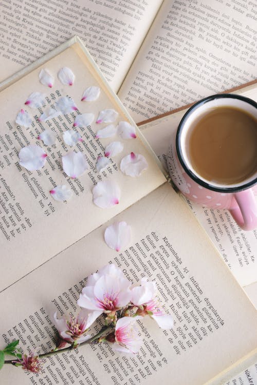 Cup of Coffee Beside a Book