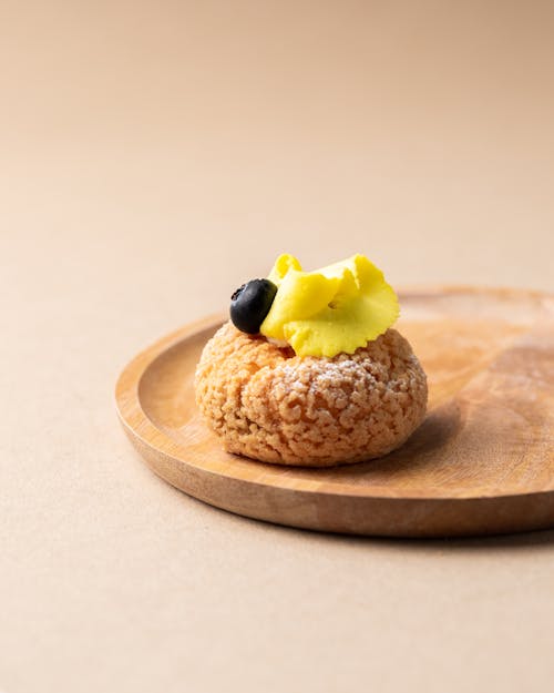 Baked Food With Cream and Blueberry on a Wooden Tray