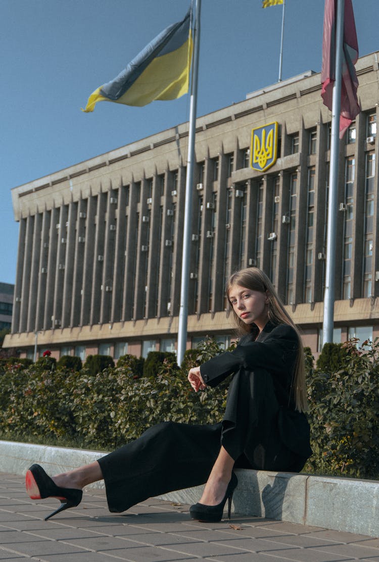 Blonde Woman In High Heels Sitting In Front Of The Zaporizhzhia Oblast Council