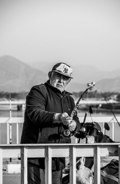 Black and White Photo of Man Fishing