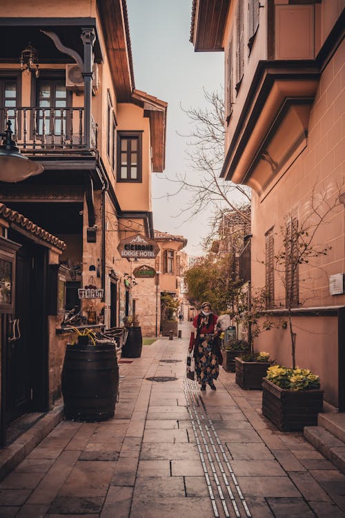 An Elderly Woman Walking on Street