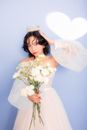 Woman in White Wedding Dress Holding White Flower Bouquet