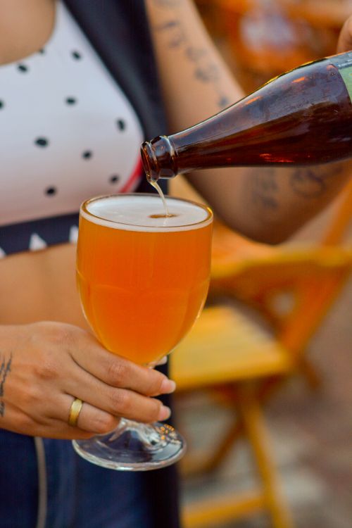 Free Close-up of fresh craft beer being poured into a glass outdoors. Stock Photo