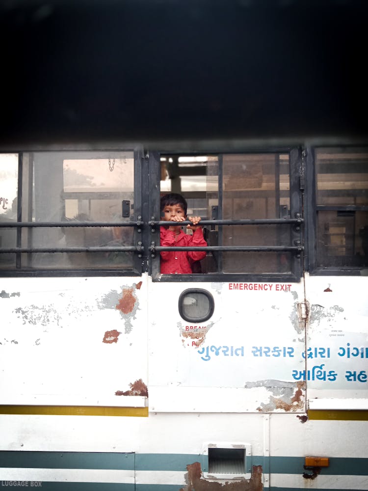 Child Looking Out The Bus Window 