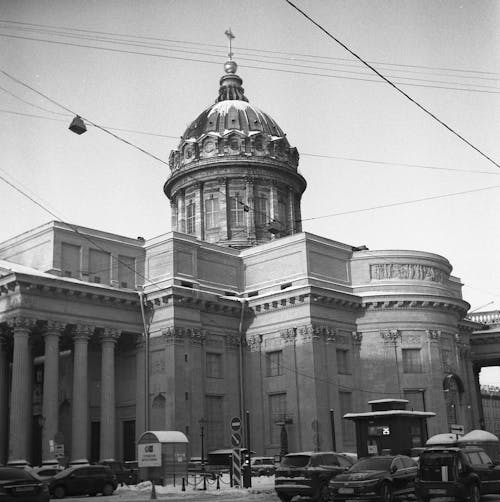 Grayscale Photo of Parked Cars Near a Church Building