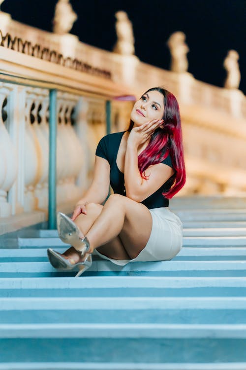 A Woman in Skirt Sitting on a Stars