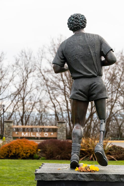 Statue of a Man with Prosthetic Leg Standing 