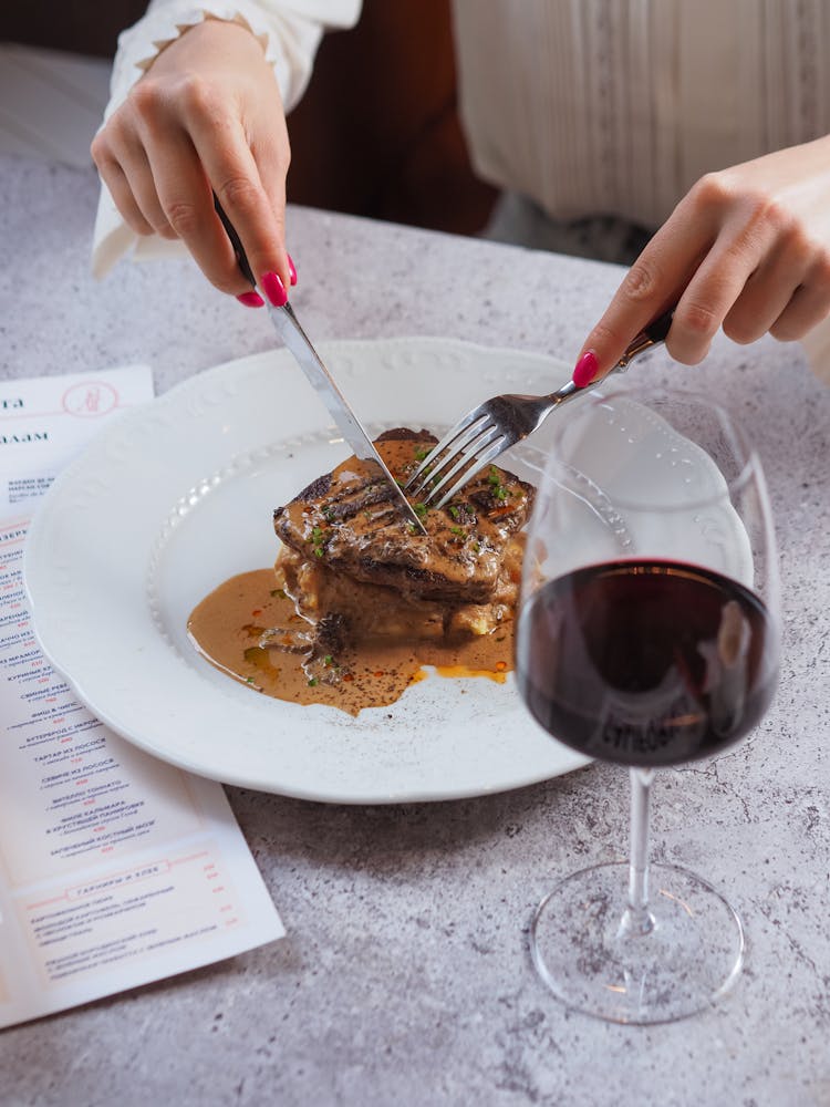 Woman Eating A Steak