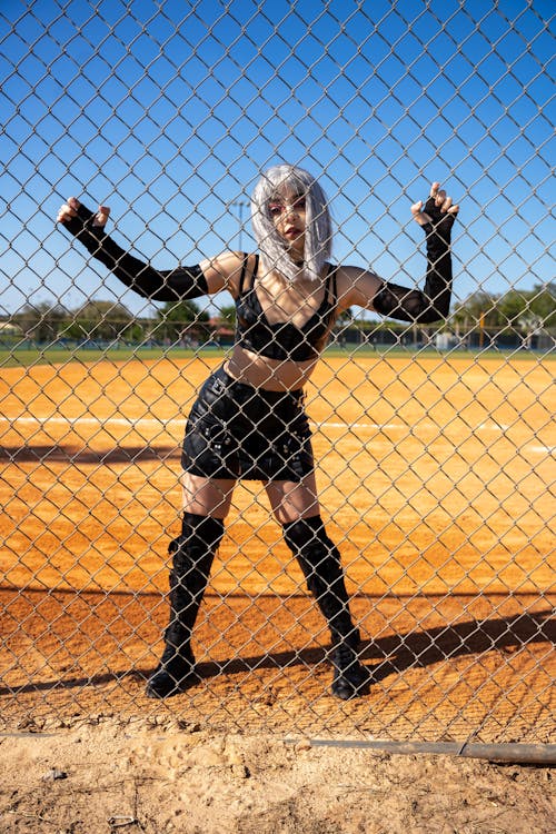 Woman Behind Chain Link Fence