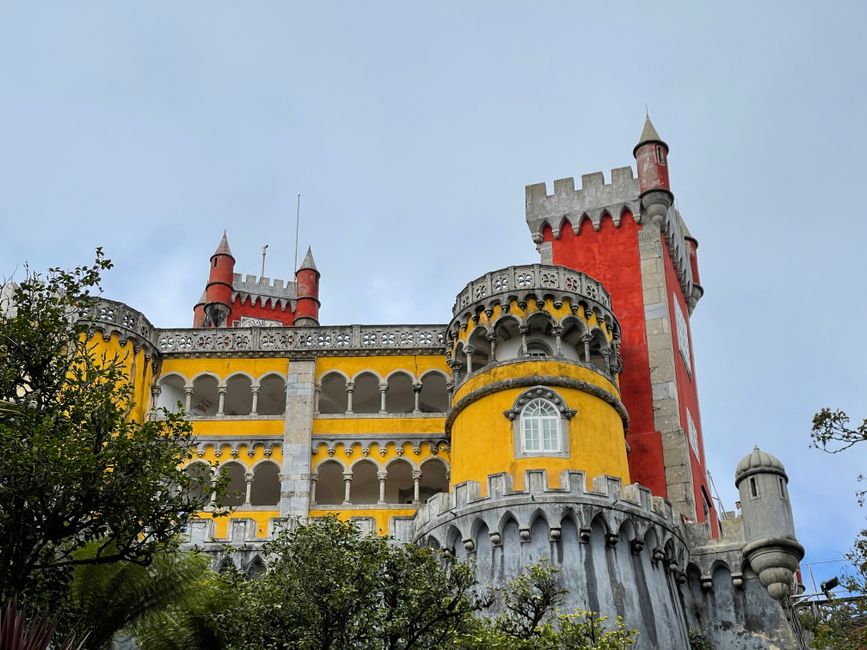Colorful view of Pena Palace's unique towers and vibrant facade in Sintra, Portugal.