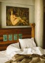 Hotel Bed with Painting Hanging Above