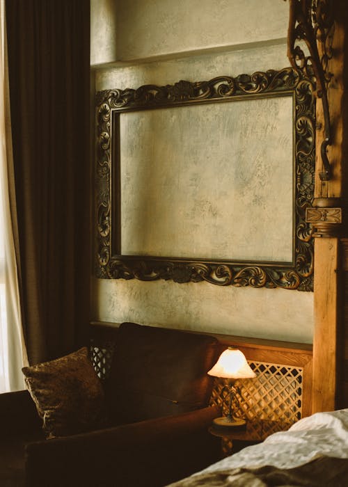 Brown Carved Frame on a Textured Wall 