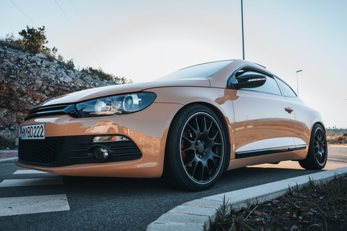 Free A sleek beige coupe parked on a road in Tivat, Montenegro, highlighting modern design and style. Stock Photo