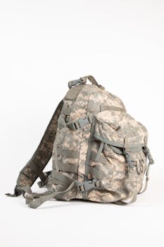 Army camouflage backpack with US print on a white surface.