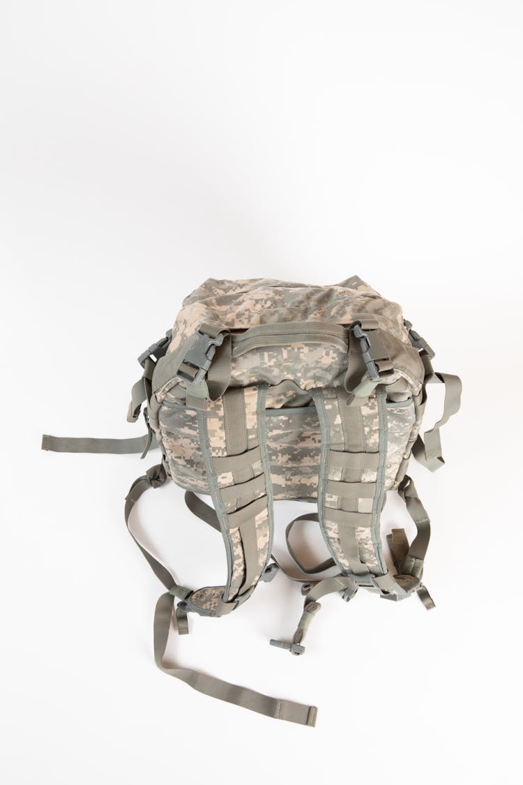 High-Angle Shot Of A Military Rucksack Bag On White Surface