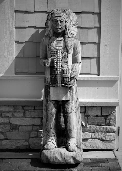 Grayscale Photo of Concrete Cigar Store Indian