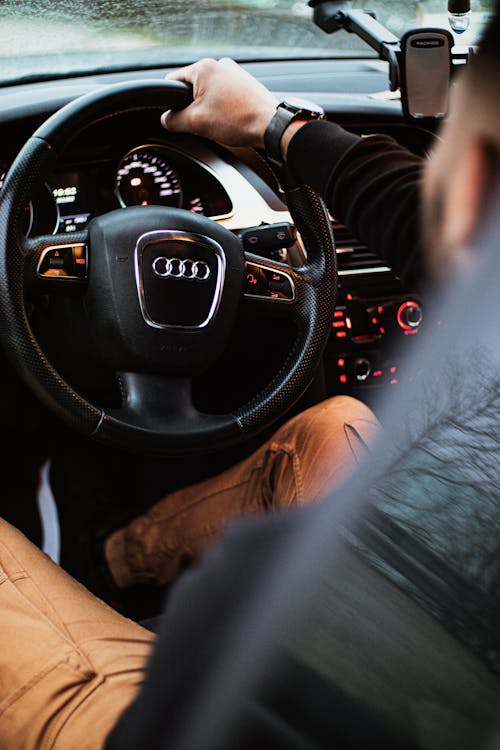 Man Holding on Steering Wheel