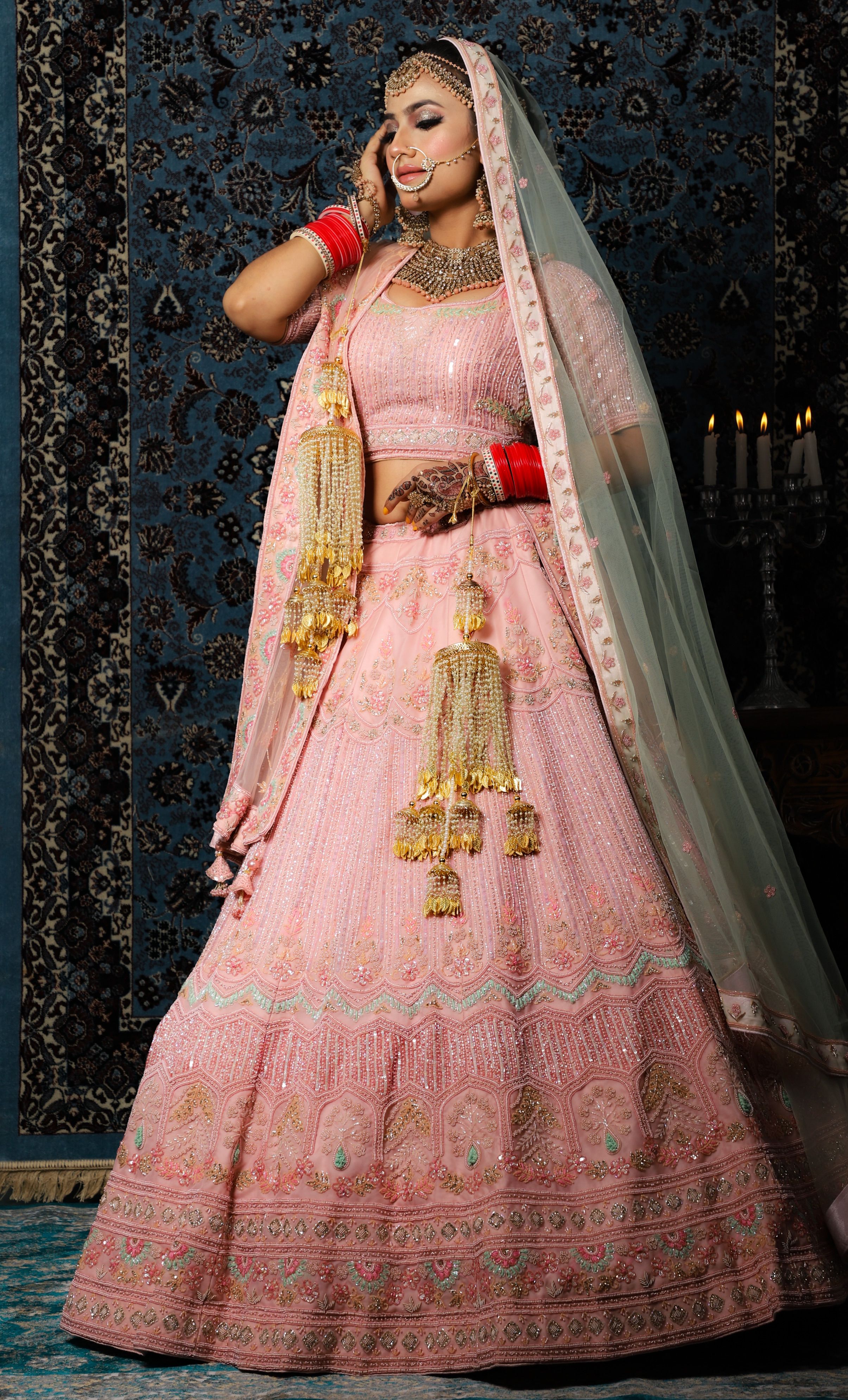 Elegant woman in bridal attire, showcasing intricate jewelry and traditional fashion.