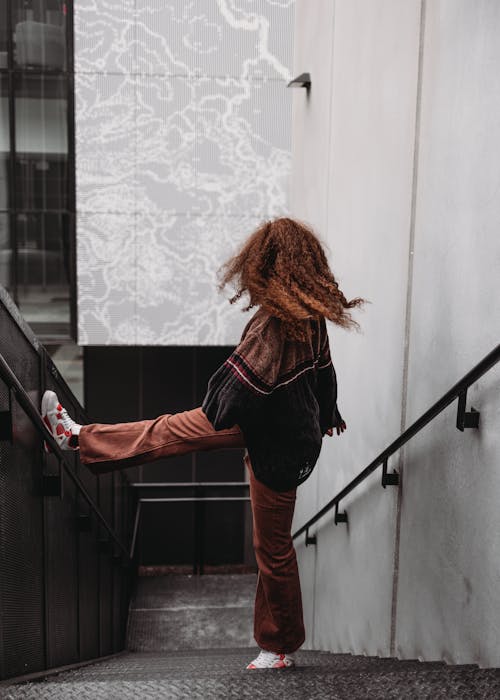 Woman Standing on Concrete Stairs