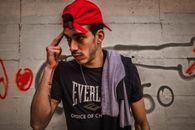 Man in Black Crew Neck T-shirt Wearing Red Cap